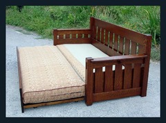 Shown with upper sofa cushion lowered to form bed.